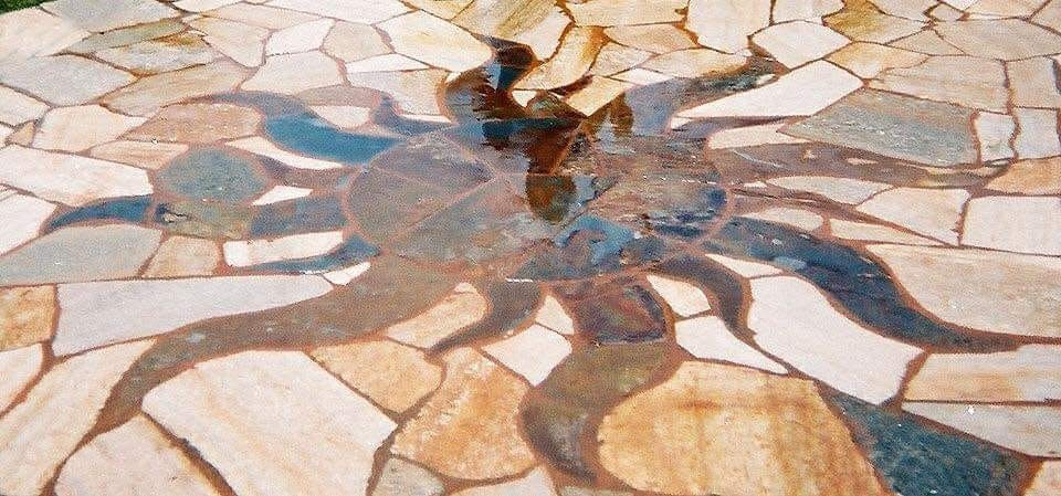 bricklayer placing bricks with trowel and mortar